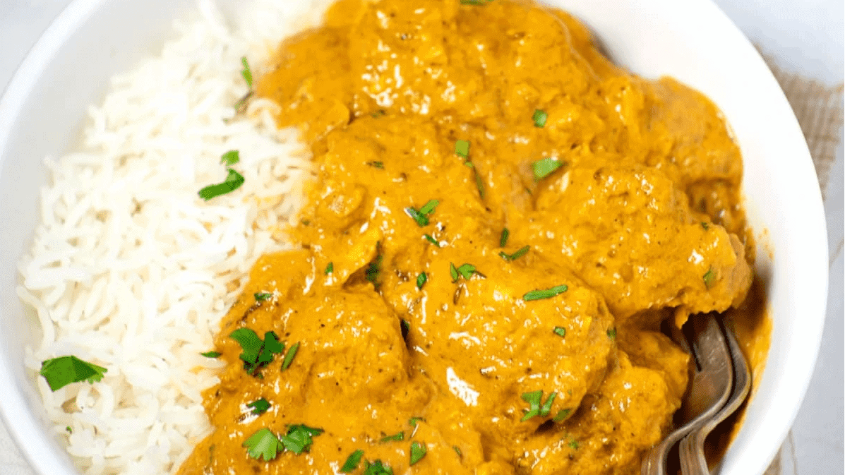 A bowl of chicken curry with rice.