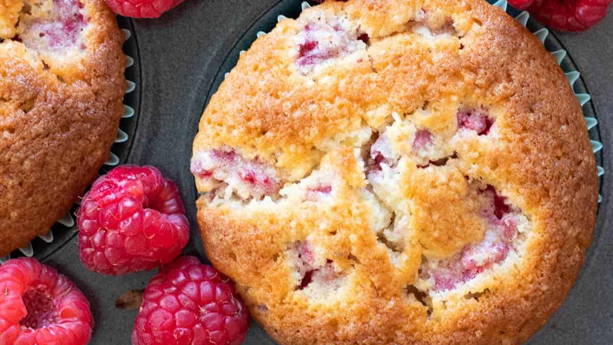 Raspberry muffins in a muffin tin.