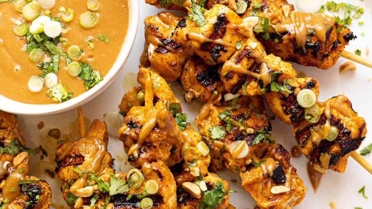 Chicken skewers with peanut sauce.