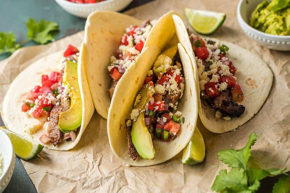 Steak tacos on a cutting board.
