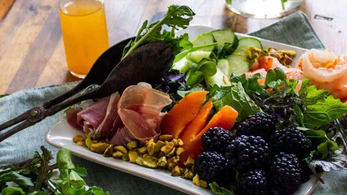 Shrimp Salad with Fruit, Mixed Greens, Prosciutto and Apricot Vinaigrette.